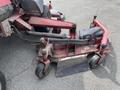 A 2012 Toro Groundsmaster 5910 featuring a mowing deck with wheels and a cutting blade attached to a red frame and hydraulic components