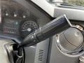 A close-up of a steering column lever from a 2016 Ford F-550 featuring control buttons for adjusting features such as speed or settings