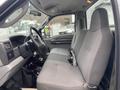 Interior of a 2003 Ford F-450 SD showing the driver's seat and steering wheel with a gray fabric upholstery