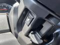 A close-up of the interior controls of a 2011 RAM 1500 showing buttons and levers for vehicle adjustments