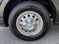 The image shows a close-up of a silver alloy wheel with a black tire marked with the brand name and model along with the Ford logo on the wheel's center cap