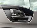 Close-up of a black door handle on the driver side of a 2022 International MV607 with two screws visible in the handle design