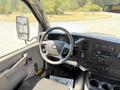 Interior view of a 2019 Chevrolet Express showing the steering wheel dashboard controls and gear shift