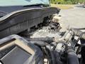 The image shows the engine compartment of a 2011 International 4300 with various pipes hoses and an exposed engine block visible