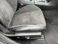 A close-up view of a black fabric car seat in a 2022 Dodge Charger with a stitching detail and adjustment lever visible