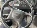 A close-up view of the steering wheel of a 2012 Workhorse W62 with the brand logo visible and dashboard gauges in the background