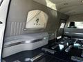 Interior of a 2013 Lincoln MKT limousine featuring plush grey seating and polished metal accents on the floor