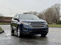 A blue 2017 Ford Edge is parked with its front facing the viewer showcasing its sleek design and distinctive grille