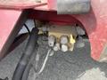 A close-up view of a Toro Groundsmaster 5910 hydraulic control valve assembly featuring multiple metal fittings and a yellow lever