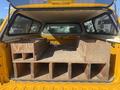A 2013 Chevrolet Silverado 1500 with a truck bed featuring wooden storage compartments for tools or equipment
