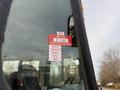 A close-up of a 2013 International 4300 truck's windshield featuring a red certificate of approval sticker with dates from January to May visible