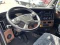 Interior view of a 2022 Freightliner Cascadia featuring a steering wheel dashboard controls and various gauges