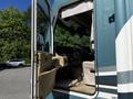A 2000 Ford Motorhome with an open door reveals a tan interior and steering wheel visible from the entrance