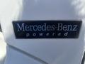 Close-up of a Mercedes-Benz powered emblem on a 2007 Freightliner M2 106 showcasing the branding of the vehicle's engine