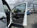 A 2021 Ford Transit Connect with the driver's side door open showcasing the interior features and door panel design
