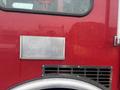A red 2006 E-One Typhoon fire truck featuring a metallic panel and a vent grille on the side with raindrops on the surface