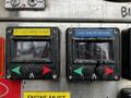 Two control panels with labeled buttons for discharge functions on a fire truck featuring discharge and foam controls