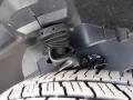A close-up view of the suspension system and tire of a 2016 Mercedes-Benz Sprinter showcasing the axle boot and tread pattern on the tire