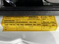 A 2021 Ford E-450 vehicle identification label displaying vehicle specifications including GVWR, type, tire size, and pressure information