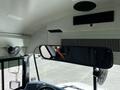 Interior view of a 2022 Blue Bird BB Conventional school bus featuring a large rearview mirror and ventilation fans mounted above the driver seat