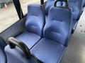 A pair of blue vinyl seats designed for a vehicle with ergonomic backs and armrests positioned side by side