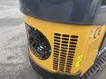 2024 AGT Industrial H13R Mini Excavator showcasing its rear grill and engine compartment with ventilation slots and caution labels