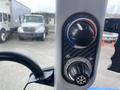 Close-up of the control panel of a 2016 New Holland T475 featuring knobs for climate control with snowflake symbols indicating cooling functions