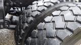 Close-up of a large tire from a 2019 Western Star Trucks 4900 featuring deep treads and rugged texture designed for heavy-duty performance