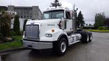 A 2019 Western Star Trucks 4900 with a shiny white exterior featuring a distinct grille and prominent headlights parked on a street