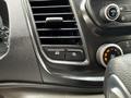 Close-up of the dashboard controls in a 2023 Ford Transit including buttons for mode and parking lights along with air conditioning and audio control knobs