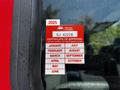 A red 2006 Emergency One Fire Truck with a visible certificate of approval sticker showing the year 2025 and months for inspection validation
