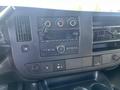 The dashboard of a 2016 GMC Savana featuring control knobs air vents and a radio display with buttons and a media player âgnoques