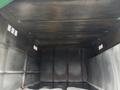 Interior of a 2015 Freightliner M2 106 truck showing dark metallic walls and vents along the upper section with a flat floor and a dull finish