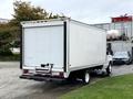 A 2022 Ford E-450 box truck with a plain white cargo area and a rear door positioned on a parking surface