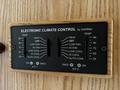 Electronic climate control panel with sliders for heat and cooling settings and temperature display marked from 50 to 90 degrees