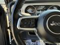 Close-up of a 2021 Jeep Gladiator steering wheel showing control buttons and the Jeep logo