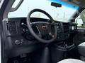 Interior view of a 2016 GMC Savana featuring a steering wheel dashboard controls and seating upholstery