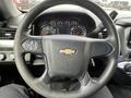 Steering wheel of a 2016 Chevrolet Tahoe featuring the Chevrolet logo and various controls for the vehicle