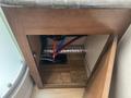 View of an open cabinet with pipes and ducts visible inside a 2016 Jayco 265RLSW camper showcasing plumbing and ventilation features