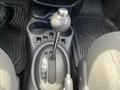 An automatic gear shift with a silver knob and gear indicator in a 2005 Chrysler PT Cruiser