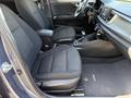 Interior view of a 2018 Kia Rio5 featuring two front seats with a textured fabric pattern and a dashboard with controls and a gear shifter