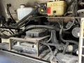 A 2008 Morgan Olson Workhorse featuring an engine compartment with mounted components including a black electronic control unit and various cables and hoses