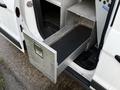 A metal storage drawer extending from the rear of a 2017 Ford Transit Connect van
