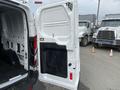 White 2017 Ford Transit van with an open side door revealing the interior space
