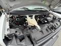 The image shows the open hood of a 2017 Chevrolet Express revealing the engine compartment with various components and hoses visible
