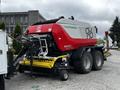 A 2020 Pottinger Impress baler with a red and white body and large wheels designed for agricultural use
