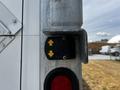 A control panel on the side of a 2019 International 4300 featuring up and down arrows indicating functionality