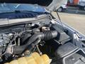 A 2017 Ford F-150 engine compartment showing the air intake system along with various engine components and fluid containers