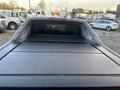 A 2011 Chevrolet Avalanche with a closed tonneau cover viewed from the rear showing the truck bed area and rear cab