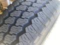 Close-up of a tire with deep treads designed for off-road traction showcasing the rugged pattern of the rubber tread